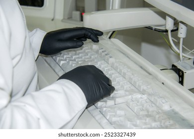 Doctor with white robe and black gloves typing on kekyboard - Powered by Shutterstock