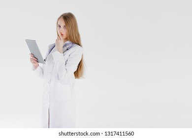 Doctor woman blond beautiful gray light day one stethoscope negative sadness model studio looks tablet thinks alone. Concept problems incurable illness luck bad medicine. - Shutterstock ID 1317411560