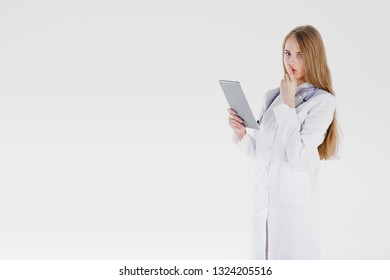 Doctor woman blond beautiful gray light day one stethoscope negative sadness model studio looks tablet thinks alone. Concept problems incurable illness luck bad medicine. - Shutterstock ID 1324205516