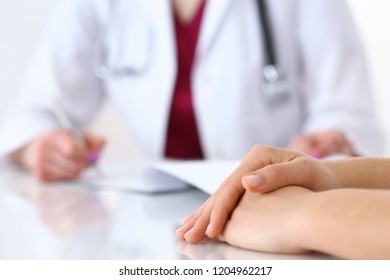 Doctor Woman Consulting Patient While Filling Up An Application Form At The Desk In Hospital. Just Hands Close-up. Medicine And Health Care Concept