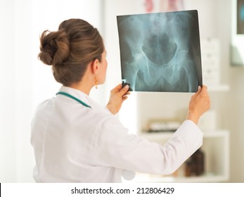 Doctor Woman Looking On Fluorography. Rear View