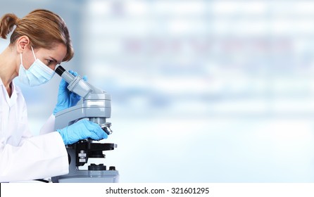 Doctor Woman With Microscope In Laboratory. Scientific Research.