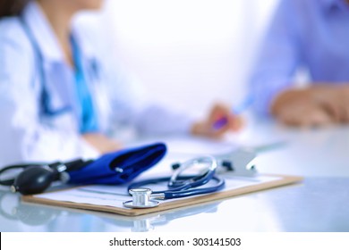 Doctor woman sitting with  male patient at the desk