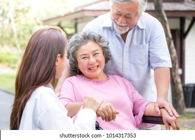 Doctor woman take care to elder patient at park.