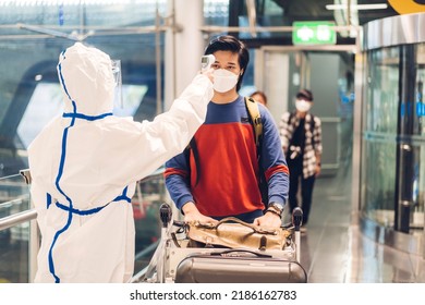 Doctor Woman Use Infrared Forehead Thermometer For Checking Body Temperature Scan Travel Passenger Fever In Quarantine For Coronavirus Wearing Safety Protective Mask At International Terminal Airport