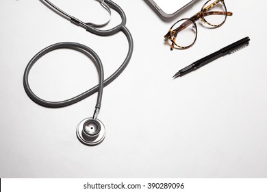 Doctor Work Tools On White Wood Desk Top View.