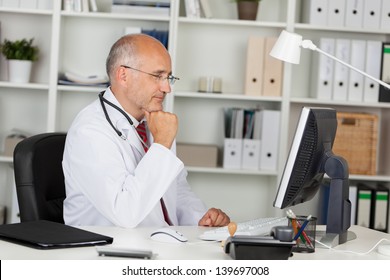 Doctor Working With Computer In Office