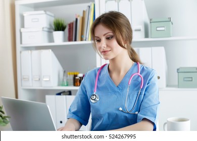 Doctor Working At Her Office. Female Physician Typing Or Reading Something An Laptop. Diagnostic, Healthcare, Medical Service, Consultation Or Education, Healthy Lifestyle Concept