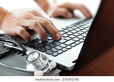 Doctor Working With Laptop Computer In Medical Workspace Office As Concept