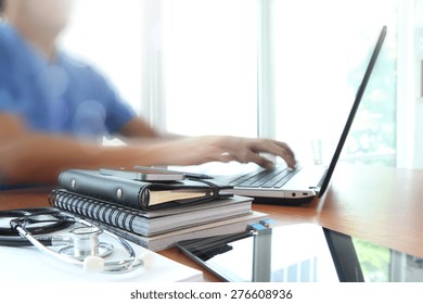 Doctor Working With Laptop Computer In Medical Workspace Office As Concept