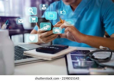 Doctor Working With Laptop And Digital Smartphone In Office At Hospital In Morning Light. Social Media Digital. 