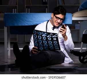 Doctor Working Night Shift In Hospital After Long Hours