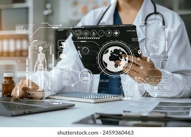 Doctor working on laptop computer and tablet and medical stethoscope on clipboard on desk, electronics medical record system EMRs concept. - Powered by Shutterstock