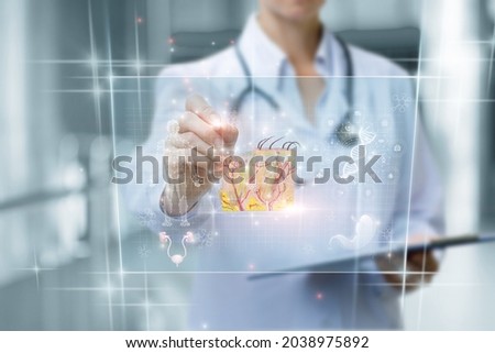 Doctor working with skin anatomy on a virtual computer screen on a blurred background.