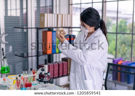 Doctor working with skull in the lab.