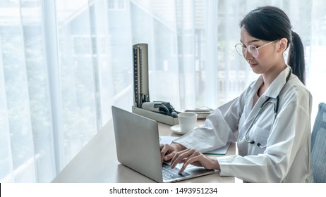 The doctor works in the office at the hospital with a computer - Shutterstock ID 1493951234