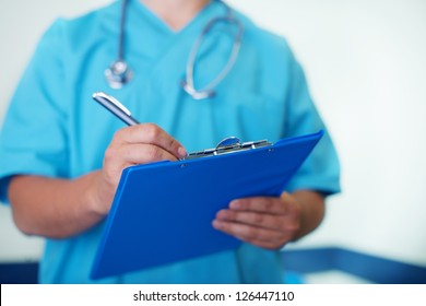 Doctor Writing Down On Medical Chart