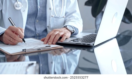 Doctor writing medical records on a glass desk with laptop. Medicine and Health Care - Powered by Shutterstock