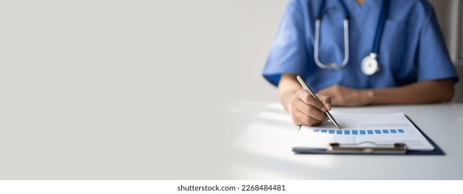 Doctor writing on a prescription note. copy space. - Shutterstock ID 2268484481