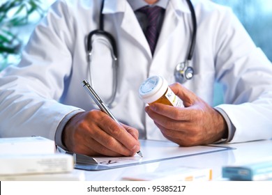Doctor writing out RX prescription selective focus - Shutterstock ID 95385217
