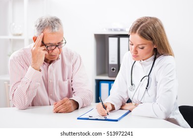 Doctor Is Writing Prescription To Her Patient.