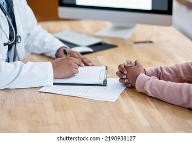 Doctor Writing A Prescription On Paper For A Patient At The Hospital. Closeup Of The Hands Of A Healthcare Professional Drafting A Medical Letter Or Form. A GP Filing A Document In An Office