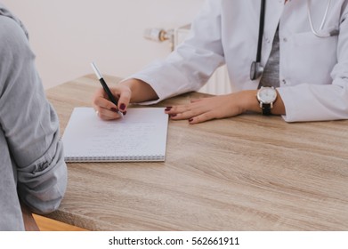 Doctor Writing A Report.