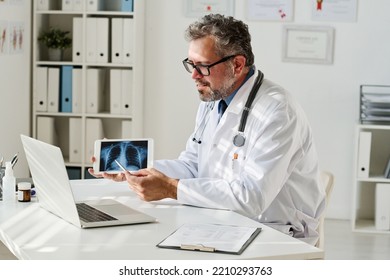 Doctor With X-ray Having Online Consultation