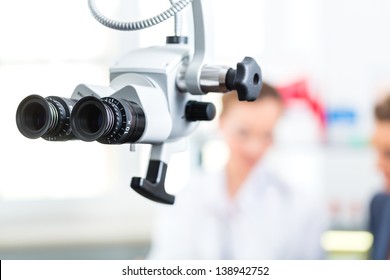 Doctor - Young Female Consultant Or ENT Specialist - With A Patient In Her Practice, In The Foreground Are Medical Tools