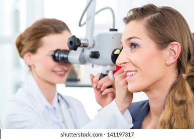 Doctor - Young Female Doctor Or ENT Specialist - With A Patient In Her Practice, Examining The Ear With A Endoscope