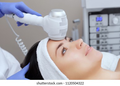 The doctor-cosmetologist makes the Cryotherapy procedure of the facial skin of a beautiful, young woman in a beauty salon.Cosmetology and professional skin care.