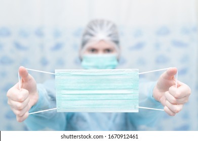 Doctor(nurse) in special suite holds a face mask as preventive measure of coronavirus (COVID-19)at hospital. - Shutterstock ID 1670912461