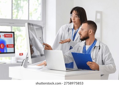 Doctors analyzing scientific data at desk in laboratory