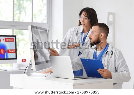 Doctors analyzing scientific data at desk in laboratory