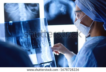 Doctors analyzing an x-ray in a meting