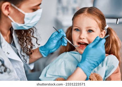 At the doctor's appointment. Portrait of a child being examined by a dentist. - Powered by Shutterstock