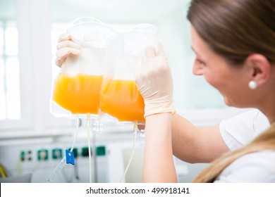 Doctors Assistant At Blood Donation Service With Plasma Donation In Blood Bag