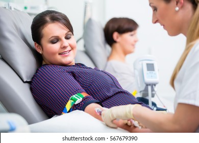 Doctors assistant checking access at female blood giver