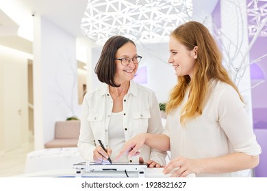 Doctor's Assistant And Doctor Plan Appointments At The Reception Desk Of A Beauty Farm