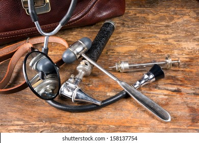 Doctor's bag and antique medical instruments such as stethoscope, reflex hammer and head mirror - Powered by Shutterstock