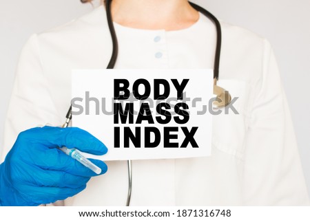 The doctor's blue - gloved hands show the word BODY MASS INDEX - . a gloved hand on a white background. Medical concept. the medicine