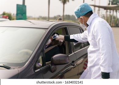 The Doctors Checking Temperature At The Temperature Check Post On The Highway Exit.