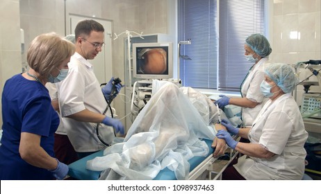Doctors conducting procedure in endoscopy room