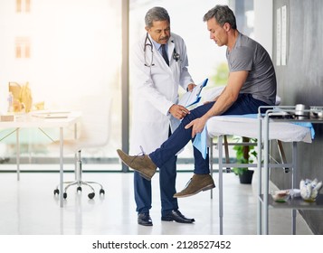 Doctors do it for the health of it. Shot of a mature doctor examining his patient who is concerned about his knee. - Shutterstock ID 2128527452