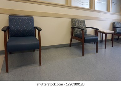 A Doctor's Empty Waiting Room With Chairs At Least Six Feet (two Meters) Apart.