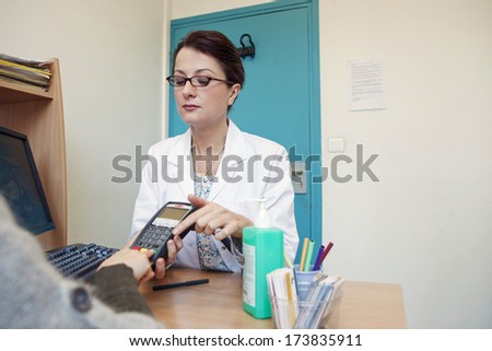 Similar – Female doctor filling out questionnaire to a senior patient