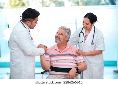 Doctors giving support to sick old man in a wheel chair - Powered by Shutterstock