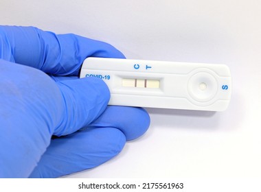 Doctor's Glove Showing The Positive Outcome Of The Covid-19 Swab Indicating That The Patient Is Suffering From This Terrible Pathology