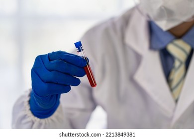 Doctor's Hand Holding A Bottle Of Blood Sample Test Tube With Blood Test Without Inscription Spot Focus, Macro, Copy Area