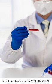 Doctor's Hand Holding A Bottle Of Blood Sample Test Tube With Blood Test Without Inscription Spot Focus, Macro, Copy Area